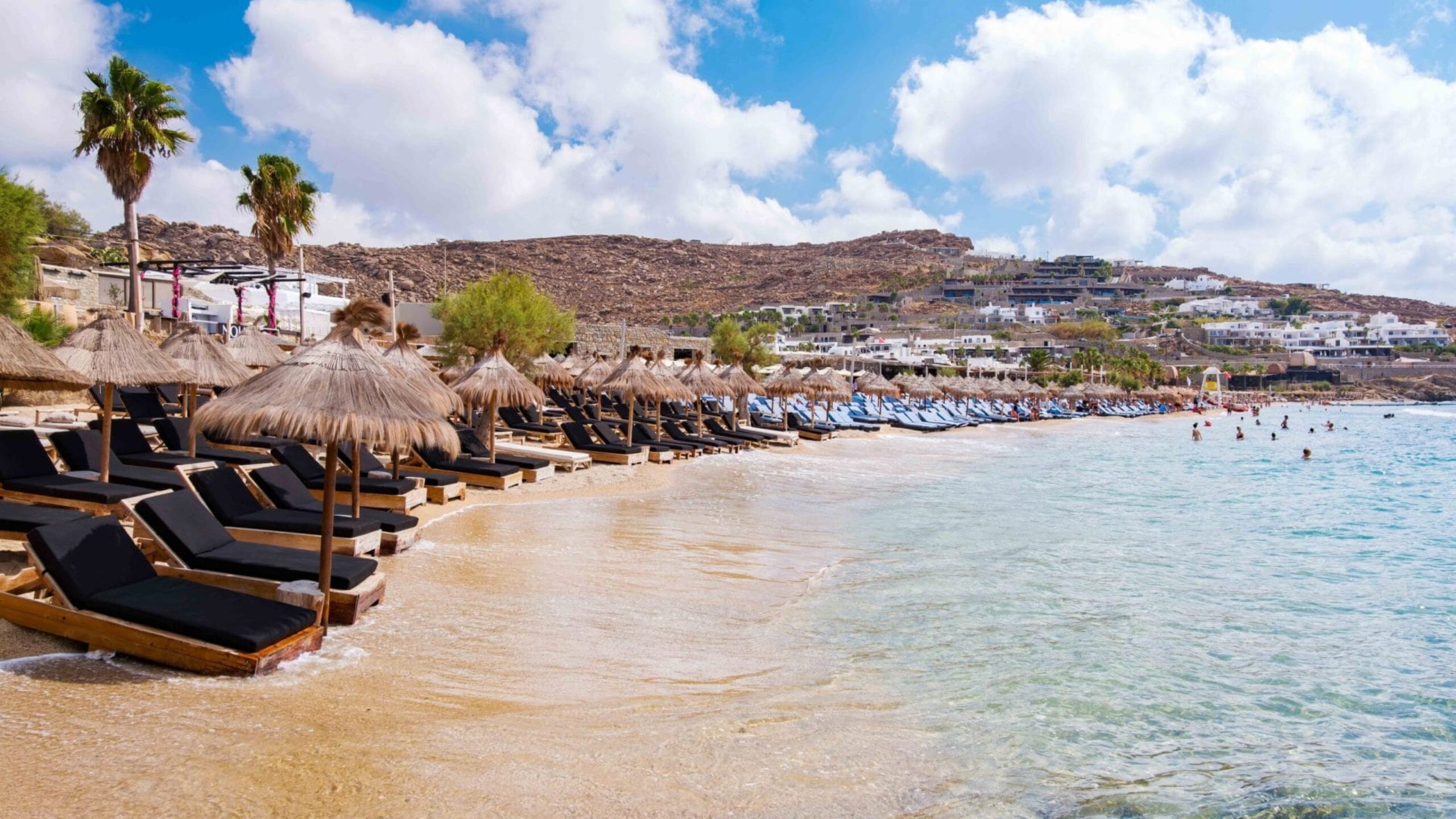Paraside,Beach,In,Mikonos,,Greece,,Umbrella,And,Luxury,Beach,Chairs Paraside Beach in Mikonos, Greece, umbrella and luxury beach chairs beds in front of blue ocean. Most famous beach with crystal water and beach music bars.