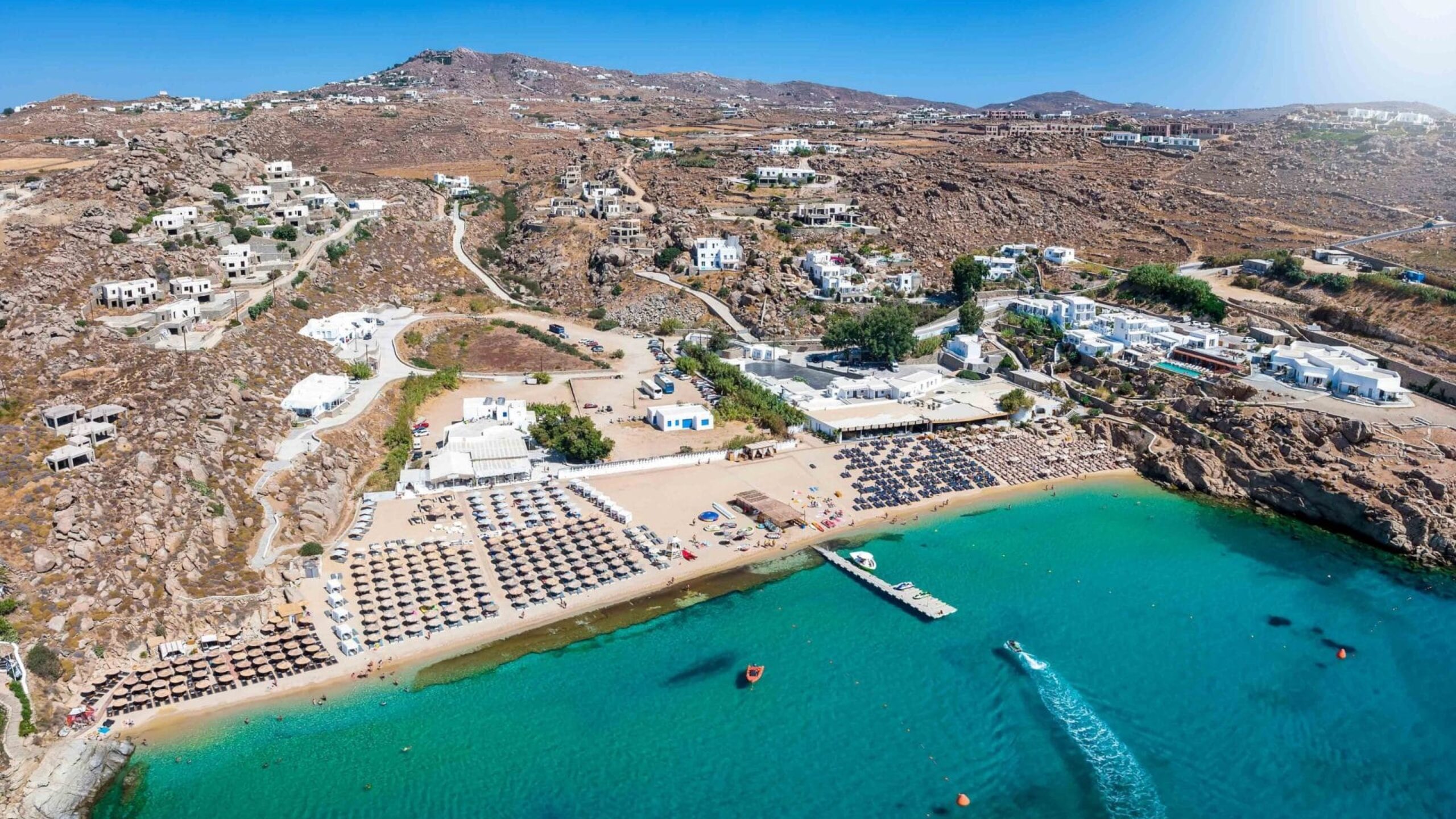 Aerial,View,Of,The,Beautiful,Super,Paradise,Beach,At,Mykonos Aerial view of the beautiful Super Paradise Beach at Mykonos island, Cyclades, Greece, during a sunny summer day